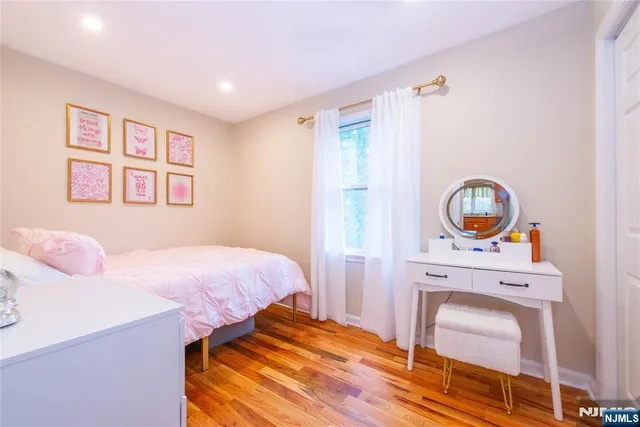 a bedroom with a bed and a chair