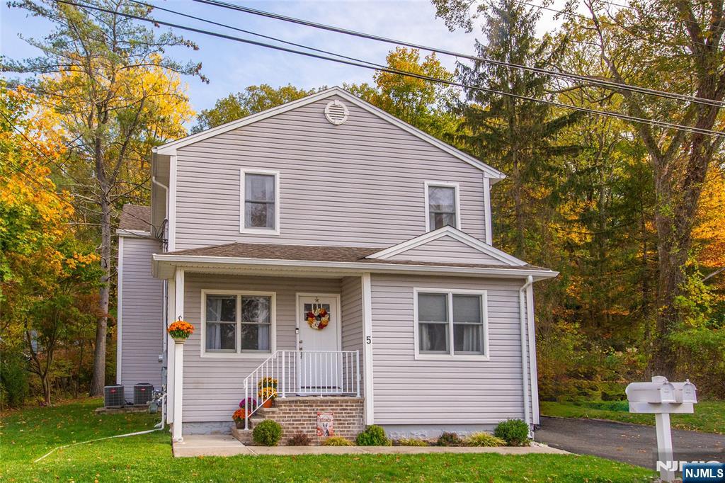 5 Mountain Avenue, Unit 2 Wanaque, NJ 07465 - Photo 16 of 20 a front view of a house with garden