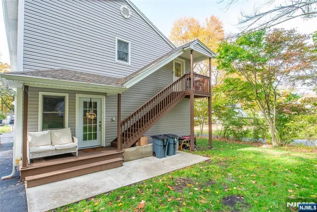 a view of a house with backyard and porch