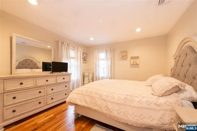 a bedroom with a large bed and a dresser