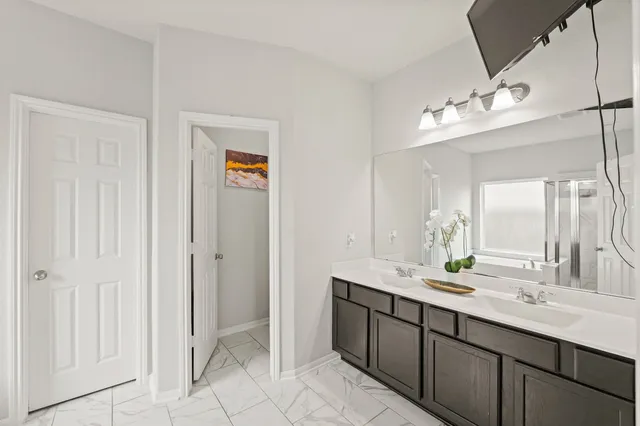 a bathroom with a double vanity sink and a mirror