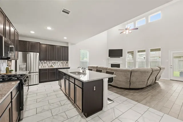a kitchen with granite countertop a sink and counter top space