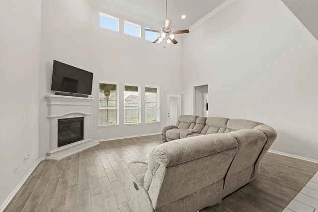 a living room with furniture a fireplace and a flat screen tv