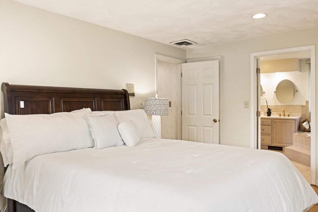 67 Sherburne Road South Lexington, MA 02421 - Photo 16 of 29 a bedroom with a large bed and a lamp