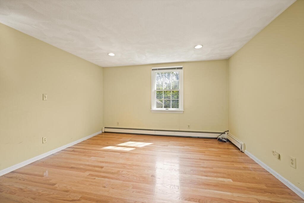 67 Sherburne Road South Lexington, MA 02421 - Photo 17 of 29 an empty room with wooden floor and windows
