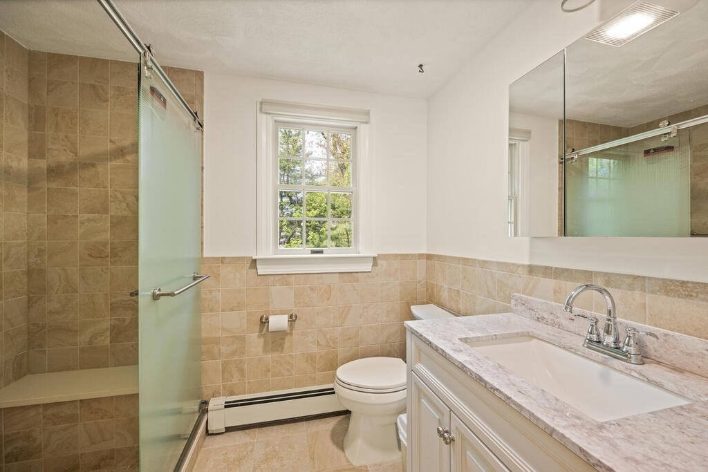 67 Sherburne Road South Lexington, MA 02421 - Photo 18 of 29 a bathroom with a granite countertop sink toilet and shower