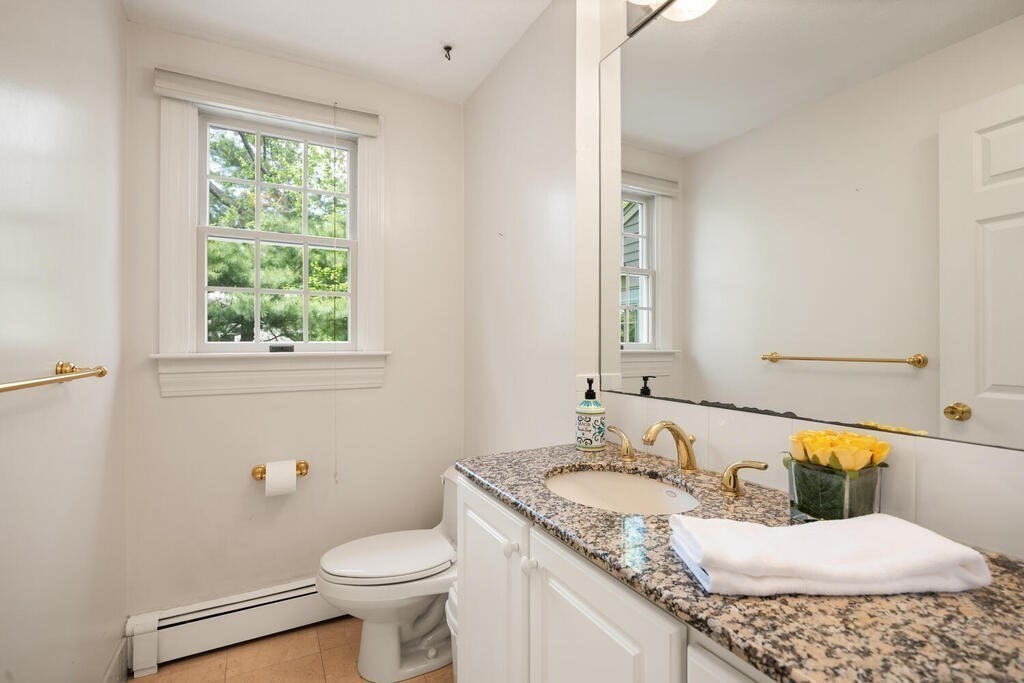 67 Sherburne Road South Lexington, MA 02421 - Photo 19 of 29 a bathroom with a granite countertop sink toilet and mirror