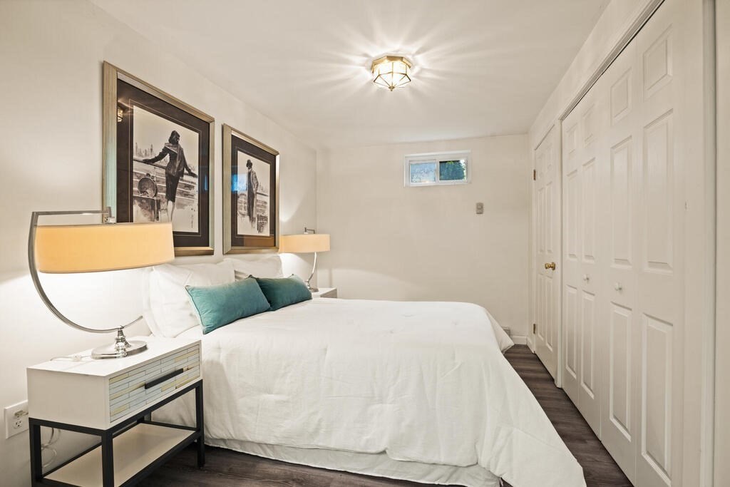 67 Sherburne Road South Lexington, MA 02421 - Photo 26 of 29 a bedroom with a bed and a chandelier