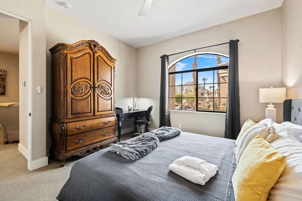a bedroom with a bed and a window