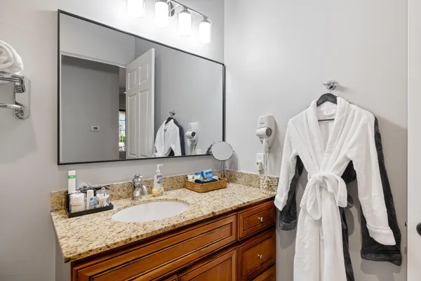 a bathroom with sink granite and a mirror