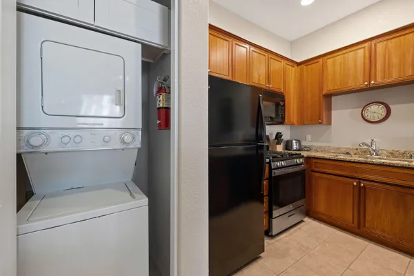 a kitchen with stainless steel appliances granite countertop a refrigerator and a stove top oven