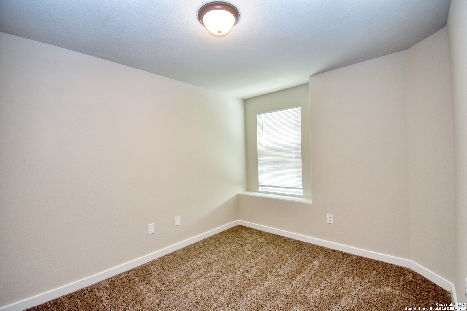 8318 Via Verona, Unit 103 San Antonio, TX 78227 - Photo 7 of 18 an empty room with a window