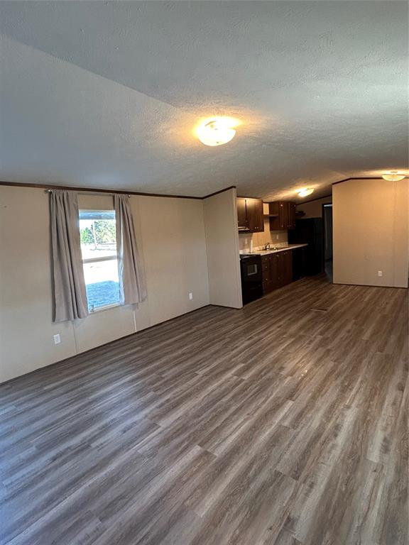 128 Blackjack Road Valley View, TX 76272 - Photo 3 of 13 an empty room with wooden floor and windows