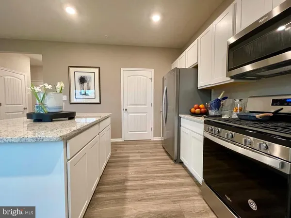 a kitchen with stainless steel appliances a sink stove and cabinets