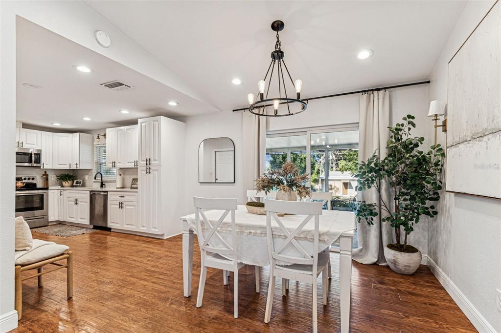 727 Locust Street Tarpon Springs, FL 34689 - Photo 11 of 47 a view of a dining room and livingroom with furniture wooden floor a chandelier