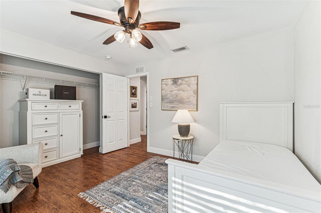 727 Locust Street Tarpon Springs, FL 34689 - Photo 18 of 47 a bedroom with a bed and a chair