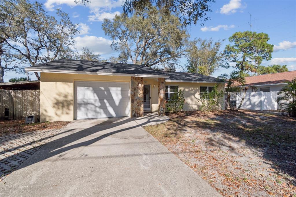 727 Locust Street Tarpon Springs, FL 34689 - Photo 2 of 47 a view of a house with a yard and large tree