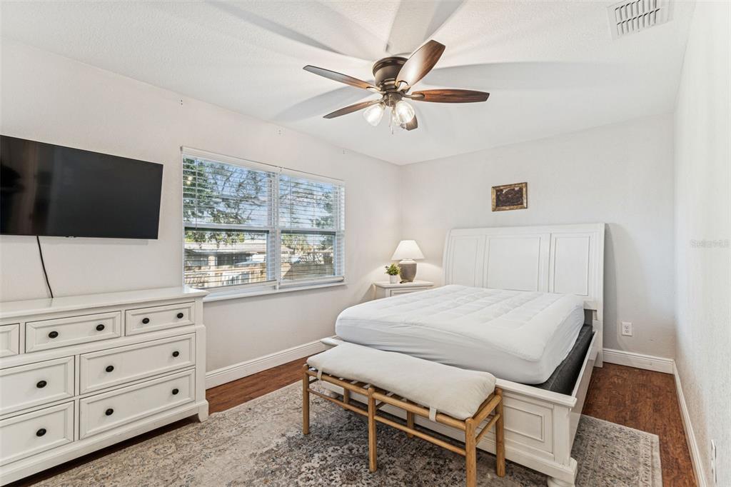 727 Locust Street Tarpon Springs, FL 34689 - Photo 21 of 47 a bedroom with a bed and a flat screen tv