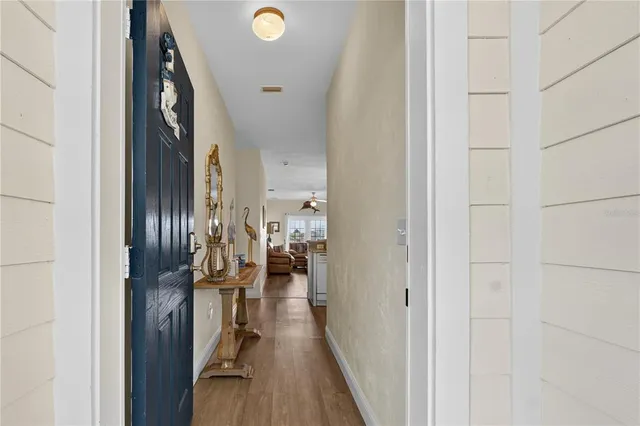 a view of hallway with wooden floor