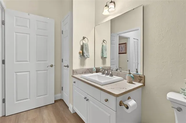 a bathroom with a double vanity sink toilet mirror and shower