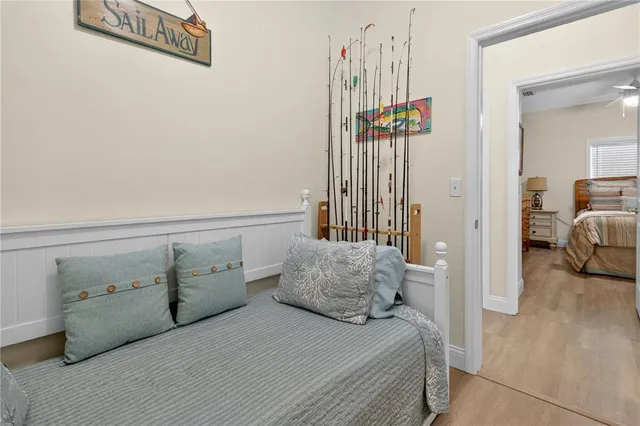 a bedroom with a bed and a chandelier