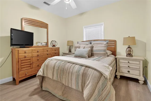 a bedroom with a bed and a painting on the wall