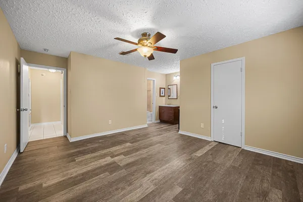 a view of empty room with wooden floor