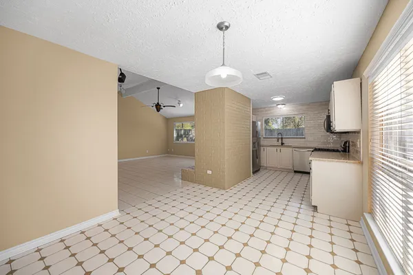 a kitchen with stainless steel appliances a refrigerator and a stove top oven