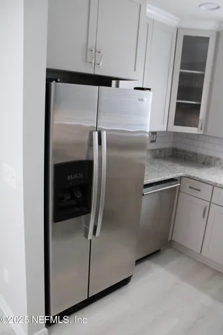 a close view of a refrigerator in kitchen and a sink