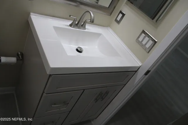 a bathroom with a sink and mirror