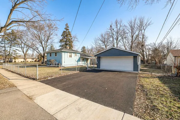a view of a house with a yard and garage