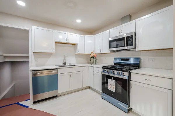 a kitchen with a sink stove and microwave