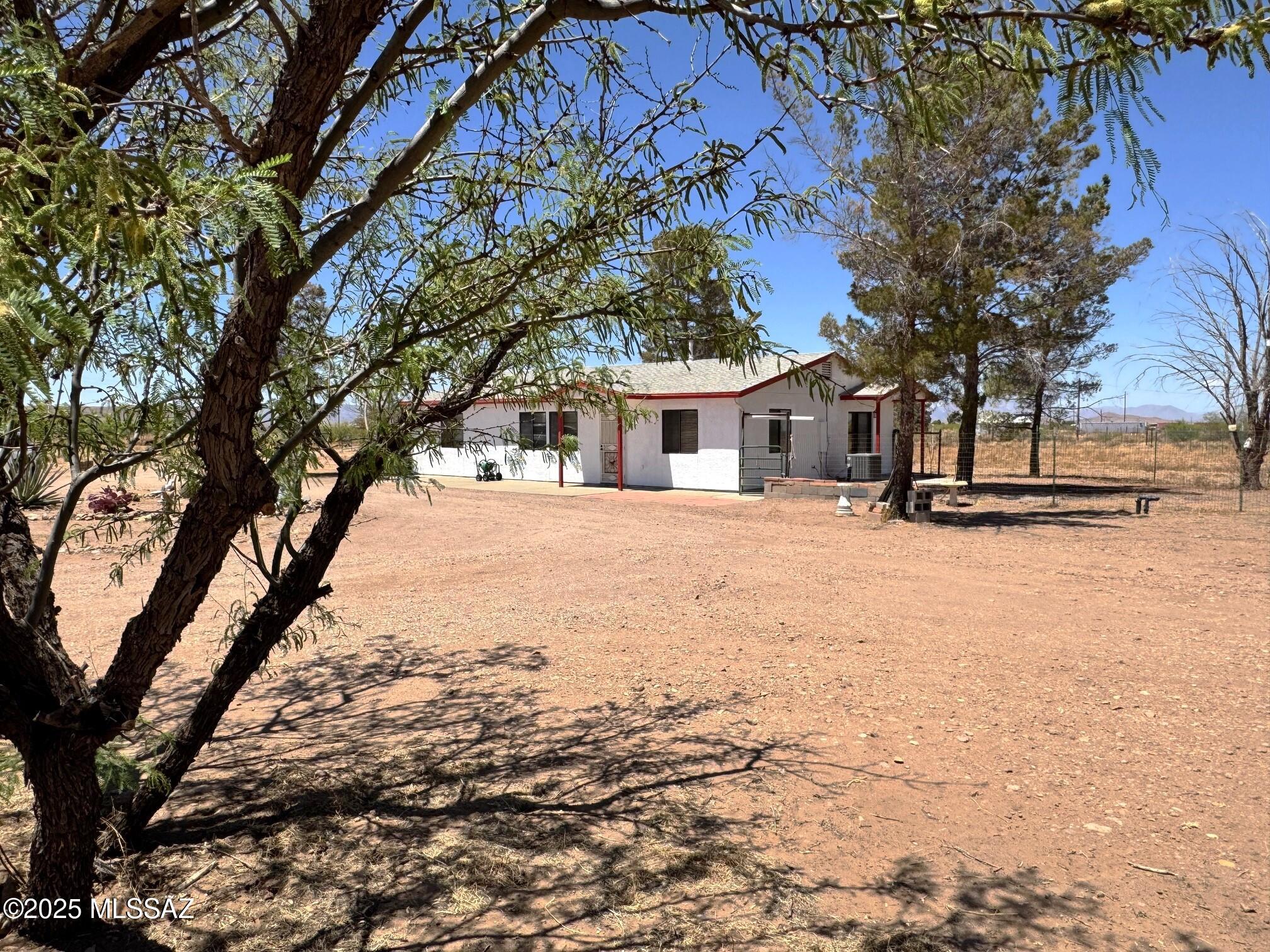 13384 South Cottonwood Road Pearce, AZ 85625 - Photo 2 of 46 a view of a yard with a tree