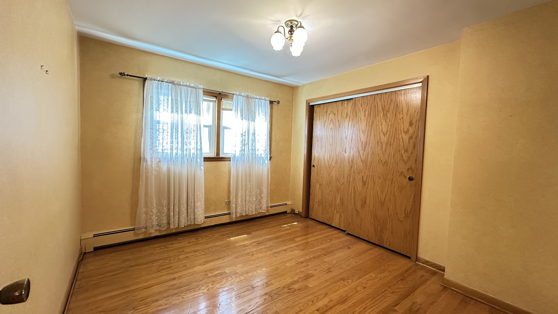 5219 North Bernard Street, Unit 1 Chicago, IL 60625 - Photo 11 of 13 an empty room with wooden floor staircase and windows