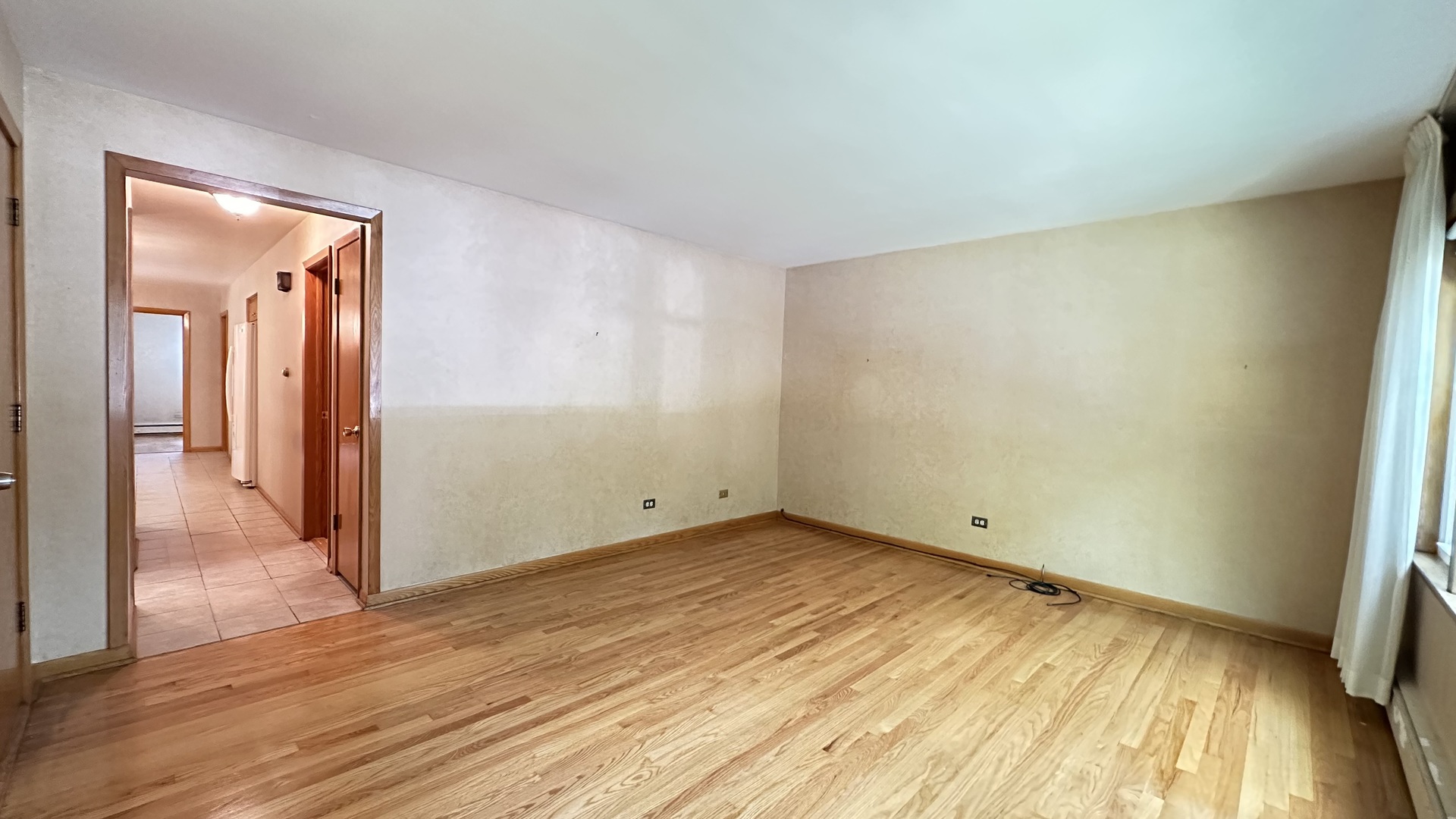 5219 North Bernard Street, Unit 1 Chicago, IL 60625 - Photo 3 of 13 a view of an empty room with wooden floor and a window