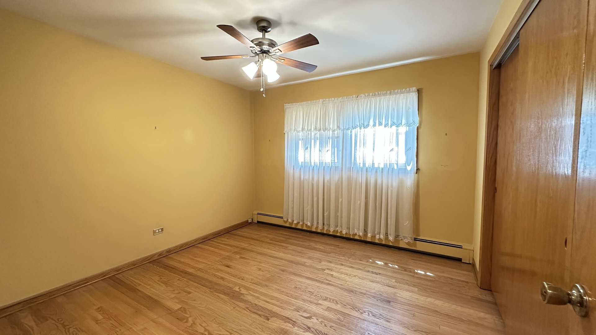 5219 North Bernard Street, Unit 1 Chicago, IL 60625 - Photo 5 of 13 an empty room with wooden floor and windows