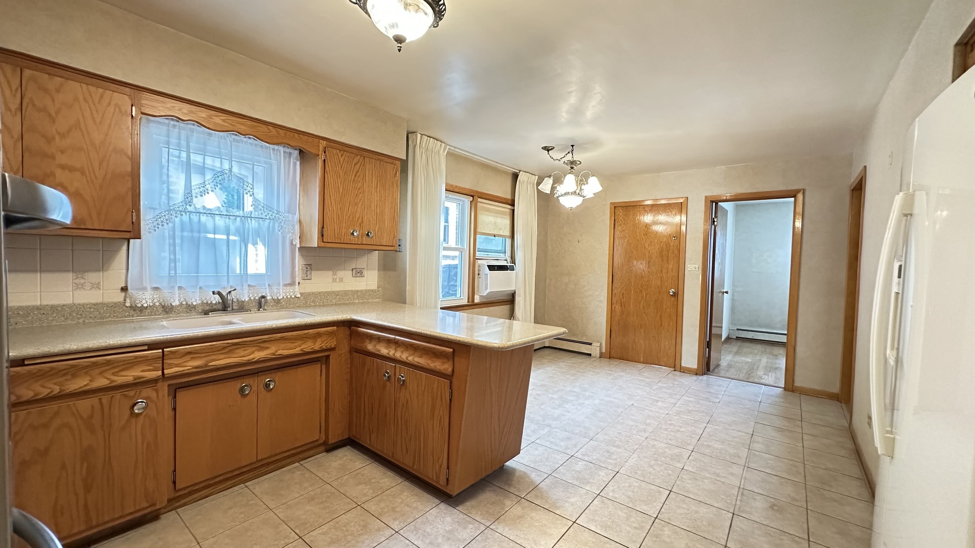 5219 North Bernard Street, Unit 1 Chicago, IL 60625 - Photo 6 of 13 a view of a kitchen with a sink and cabinets