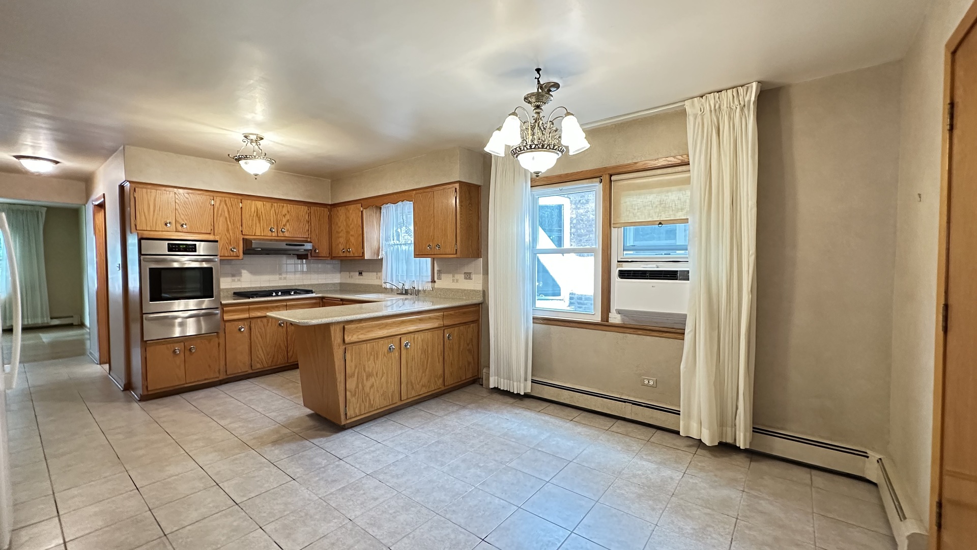 5219 North Bernard Street, Unit 1 Chicago, IL 60625 - Photo 7 of 13 a kitchen with a refrigerator and a stove top oven