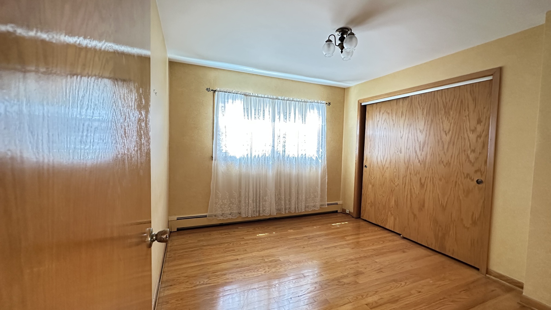 5219 North Bernard Street, Unit 1 Chicago, IL 60625 - Photo 9 of 13 an empty room with windows