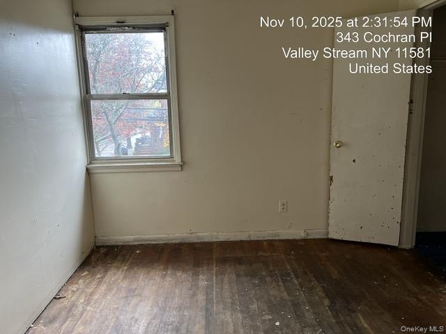 343 Cochran Place Valley Stream, NY 11581 - Photo 13 of 17 an empty room with wooden floor and windows