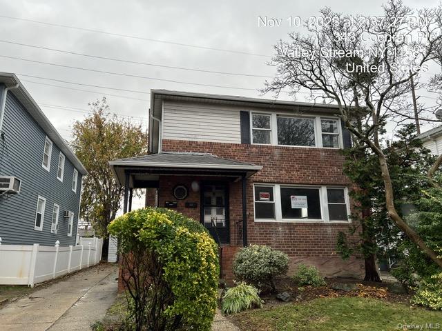 343 Cochran Place Valley Stream, NY 11581 - Photo 2 of 17 a front view of a house with garden