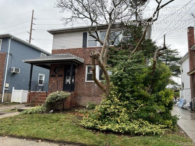 343 Cochran Place Valley Stream, NY 11581 - Photo 3 of 17 a front view of a house with a garden
