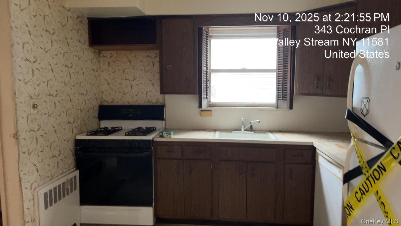 343 Cochran Place Valley Stream, NY 11581 - Photo 9 of 17 a view of a kitchen with a sink and a window