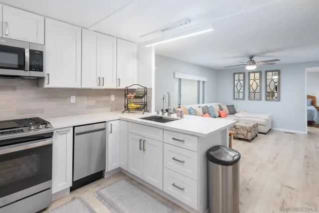 a kitchen with a sink appliances and cabinets