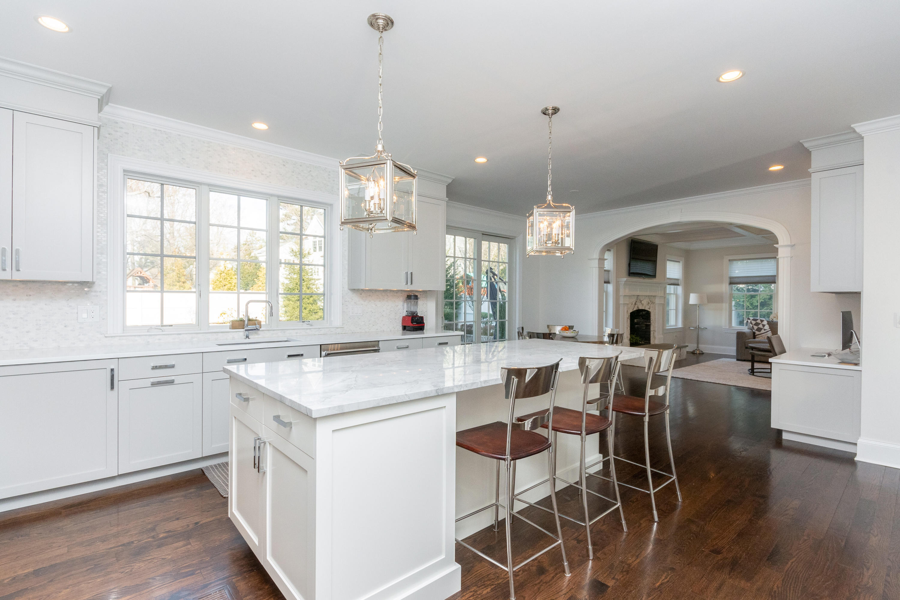 4 Echo Drive Darien, CT 06820 - Photo 13 of 40 a large kitchen with kitchen island a island a sink a stove a dining table and chairs