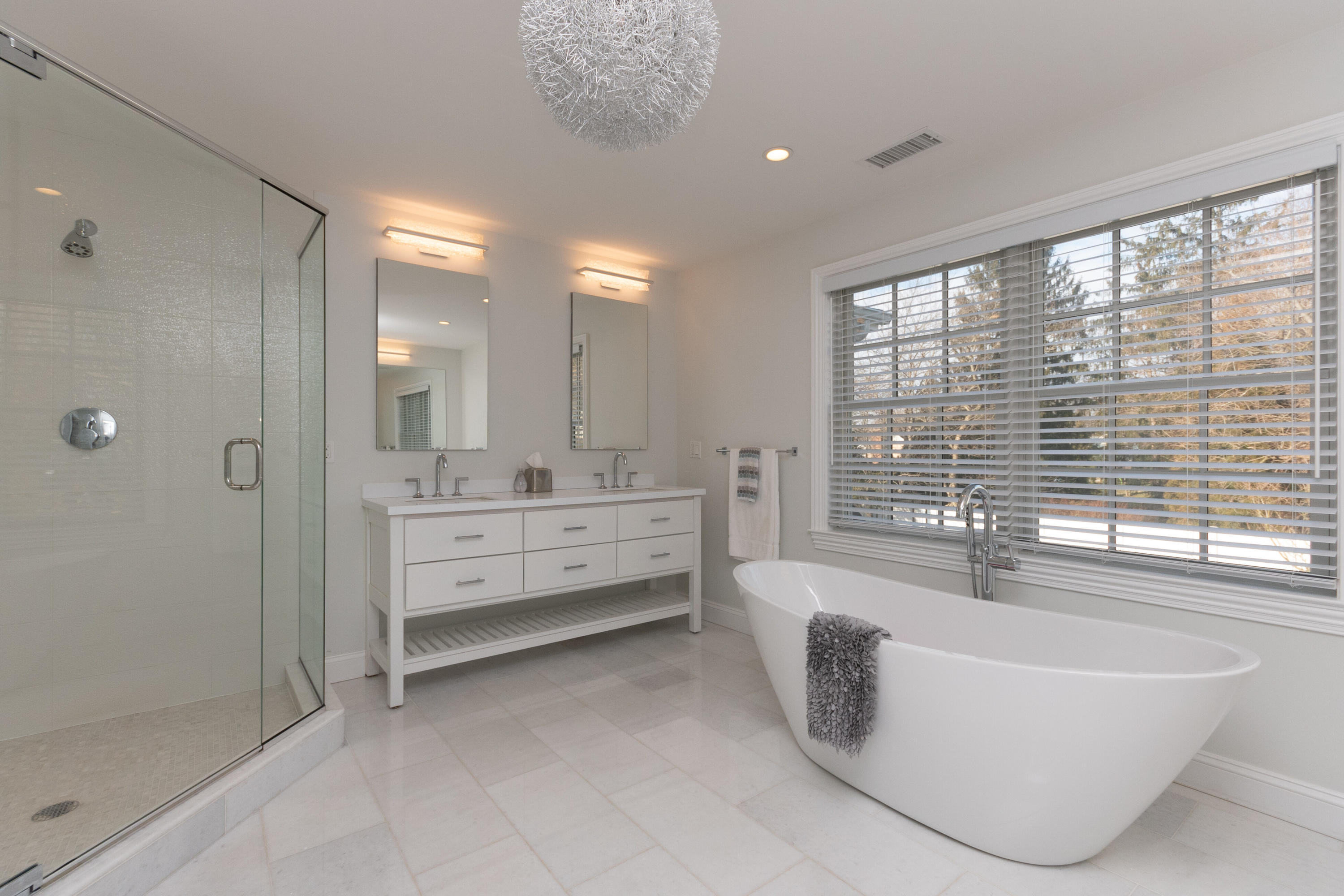 4 Echo Drive Darien, CT 06820 - Photo 25 of 40 a spacious bathroom with a tub sink shower and mirror