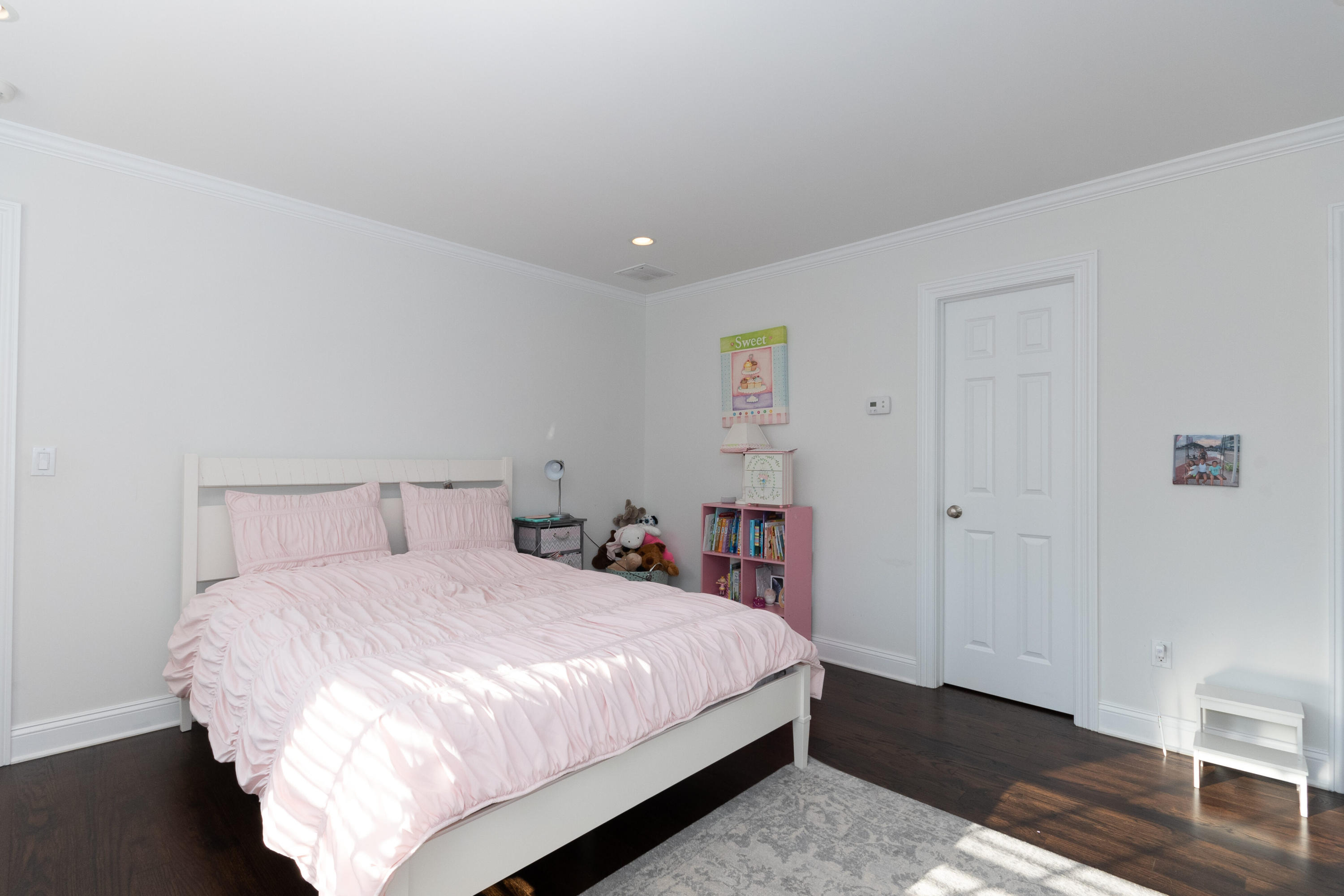 4 Echo Drive Darien, CT 06820 - Photo 28 of 40 a bedroom with a bed and wooden floor