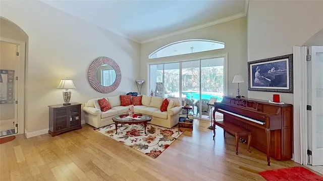 a living room with furniture a fireplace and a large window