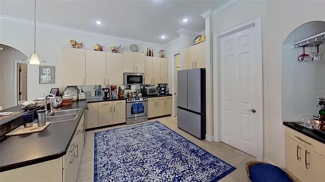 a kitchen with stainless steel appliances granite countertop a refrigerator stove microwave and sink