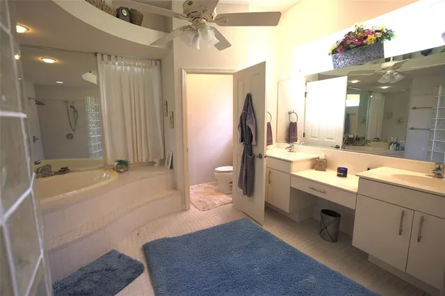 a bathroom with a tub sink and mirror